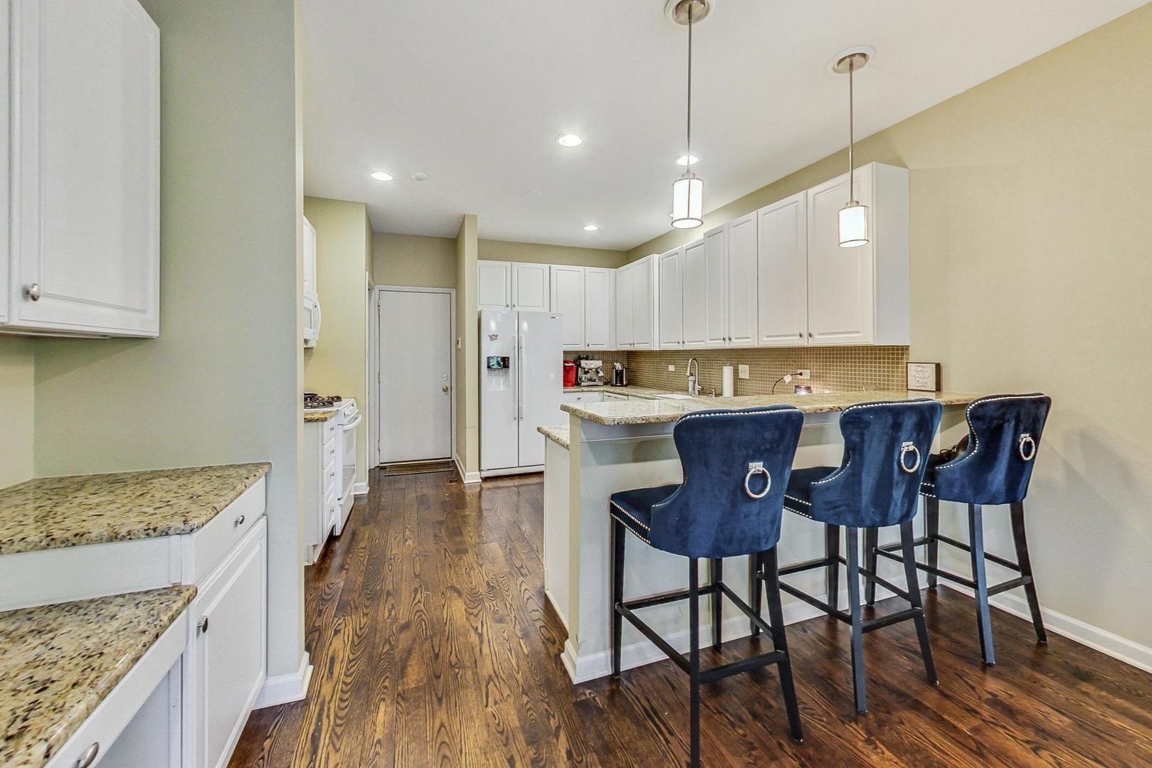74 Trent Court Burr Ridge, IL 60527 - Photo 8 of 30 a open kitchen with stainless steel appliances granite countertop a stove top oven a refrigerator a sink and chairs