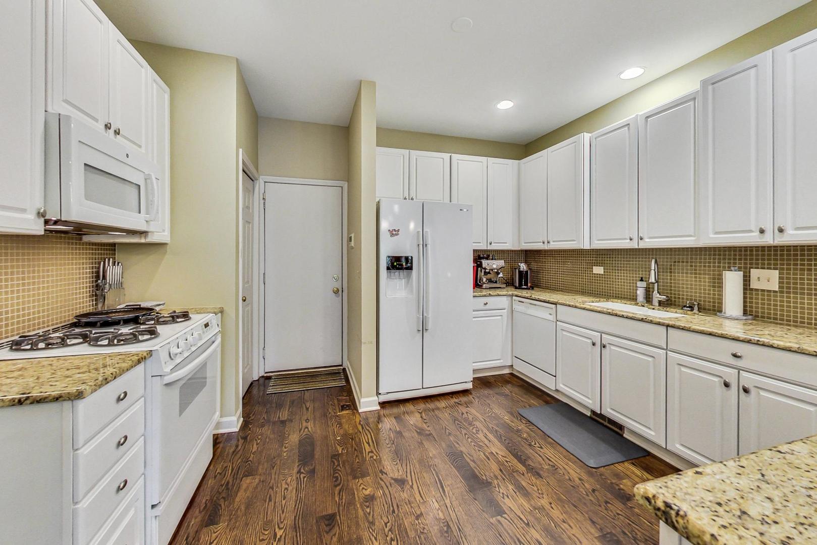74 Trent Court Burr Ridge, IL 60527 - Photo 9 of 30 a kitchen with granite countertop white cabinets and white appliances