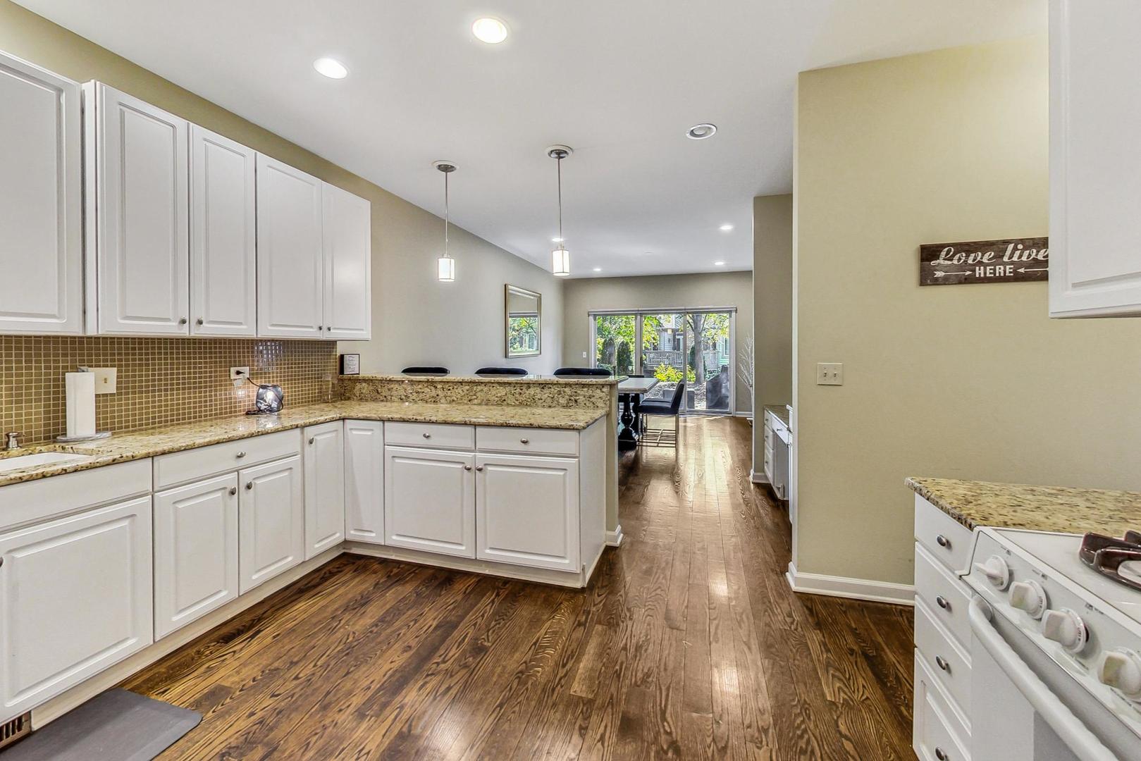 74 Trent Court Burr Ridge, IL 60527 - Photo 10 of 30 a kitchen with a refrigerator and white cabinets