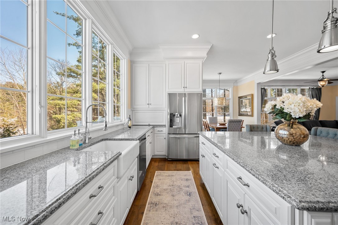 3777 Hunting Run Road Medina, OH 44256 - Photo 12 of 46 Kitchen with light stone counters, appliances with stainless steel finishes, hanging light fixtures, and white cabinets