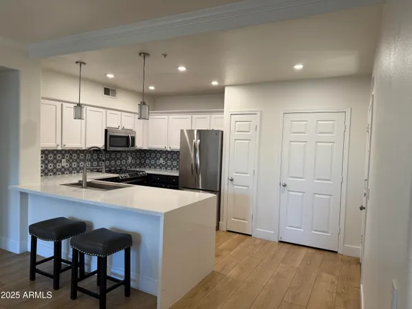 a large kitchen with a table and chairs