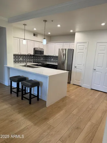 a large kitchen with a table and chairs