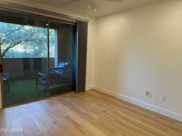 a view of a room with wooden floor and a window
