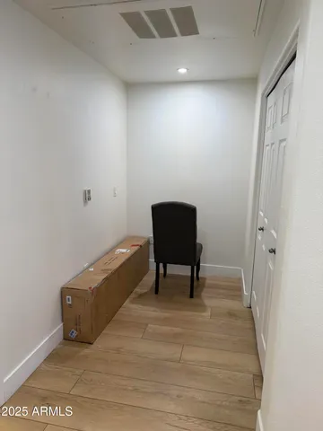 a view of a room with wooden floor and furniture