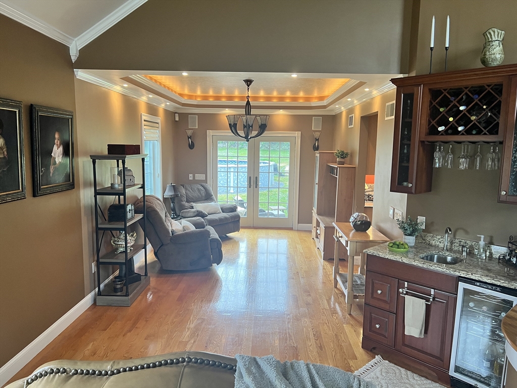 34 Base Lodge Road Swansea, MA 02777 - Photo 23 of 35 a living room with furniture a rug kitchen view and a large window