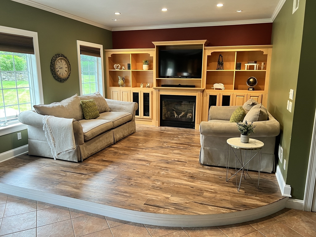 34 Base Lodge Road Swansea, MA 02777 - Photo 3 of 35 a living room with furniture a flat screen tv and a fireplace