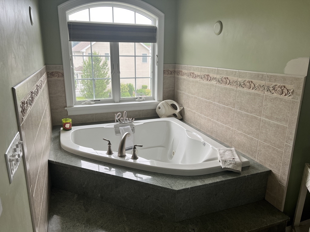 34 Base Lodge Road Swansea, MA 02777 - Photo 33 of 35 a bath tub sitting in a bathroom next to a window