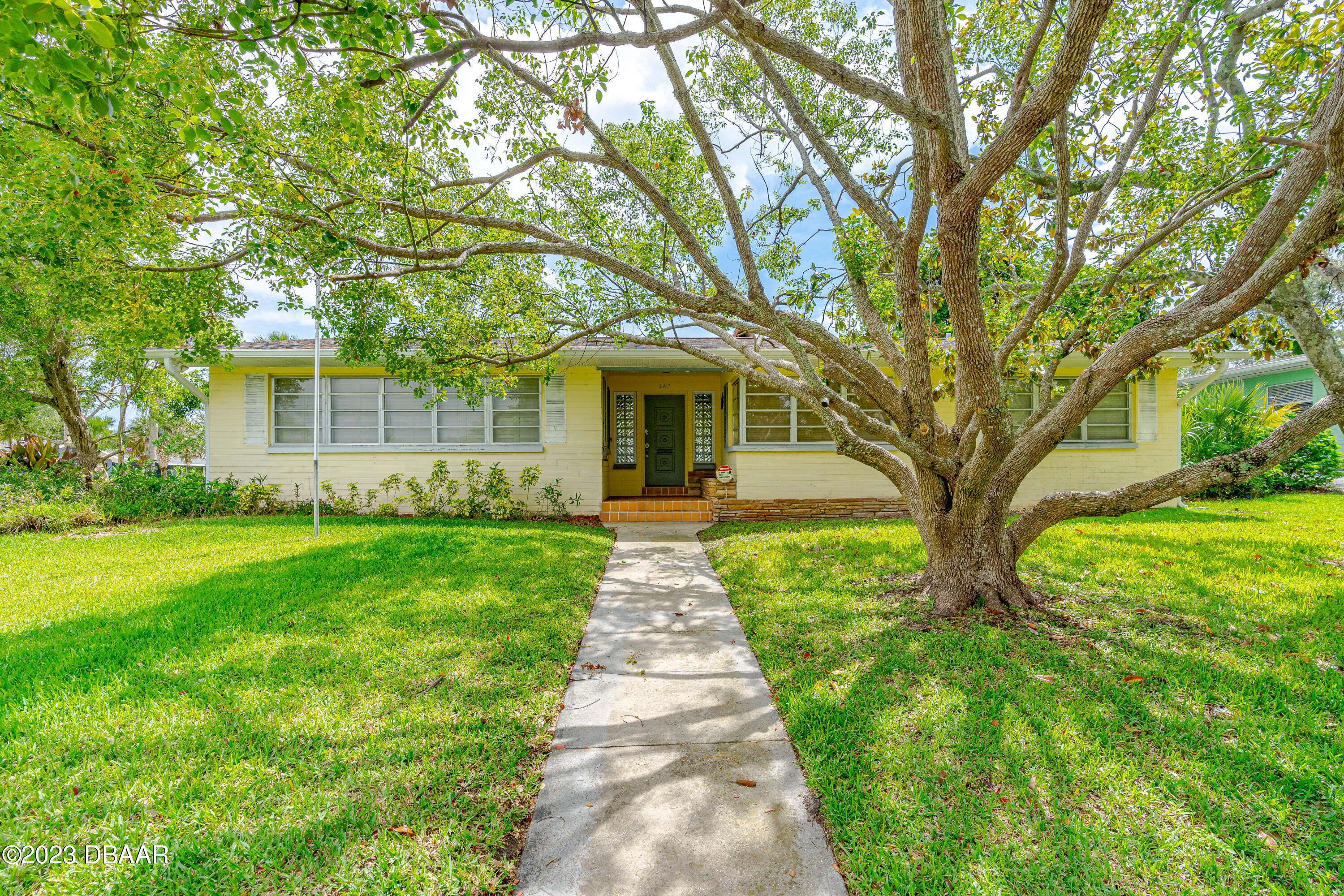 a front view of a house with garden