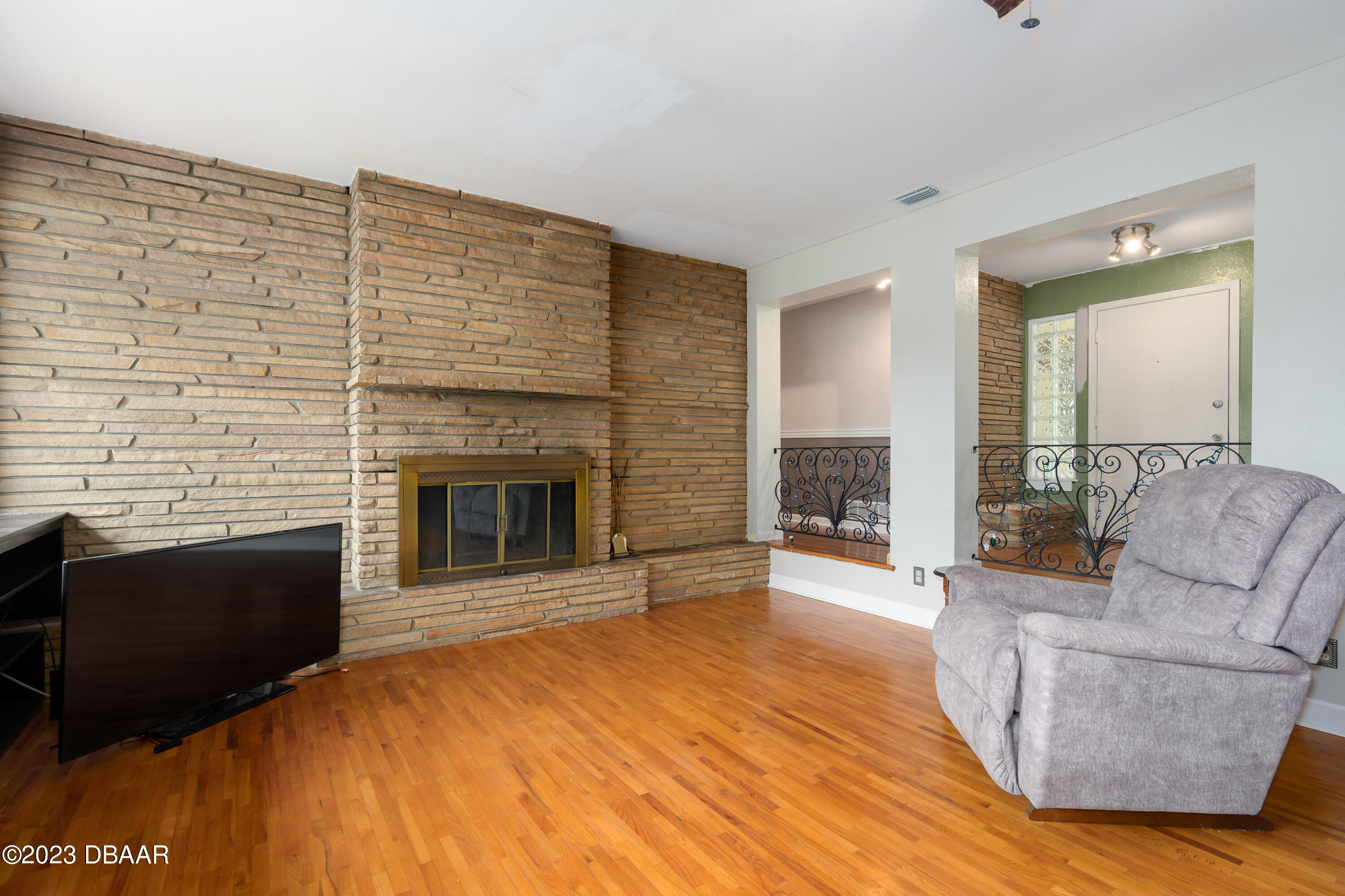 267 South Halifax Drive Ormond Beach, FL 32176 - Photo 17 of 47 a living room with furniture and a fireplace