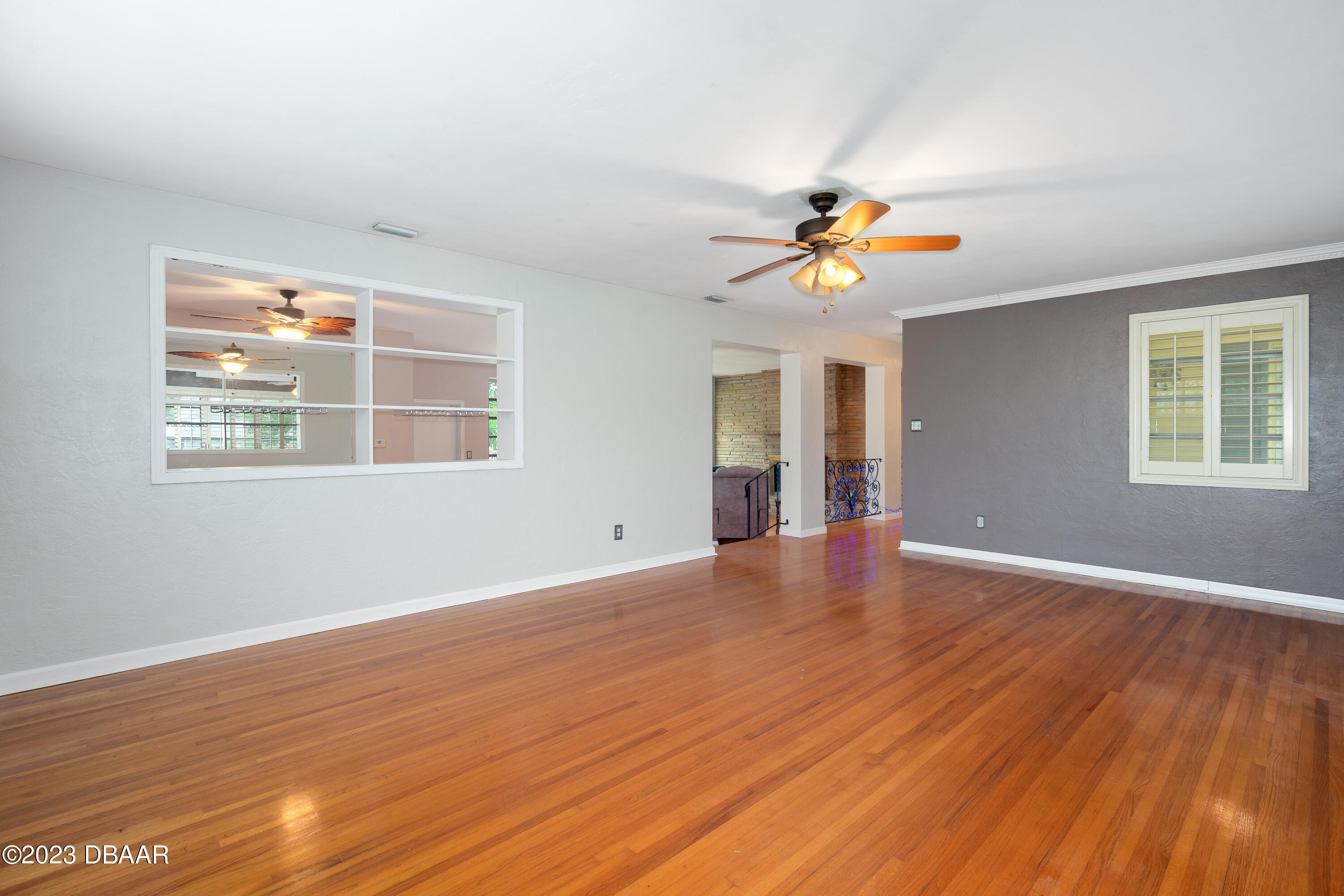 267 South Halifax Drive Ormond Beach, FL 32176 - Photo 20 of 47 a view of an empty room with window and wooden floor