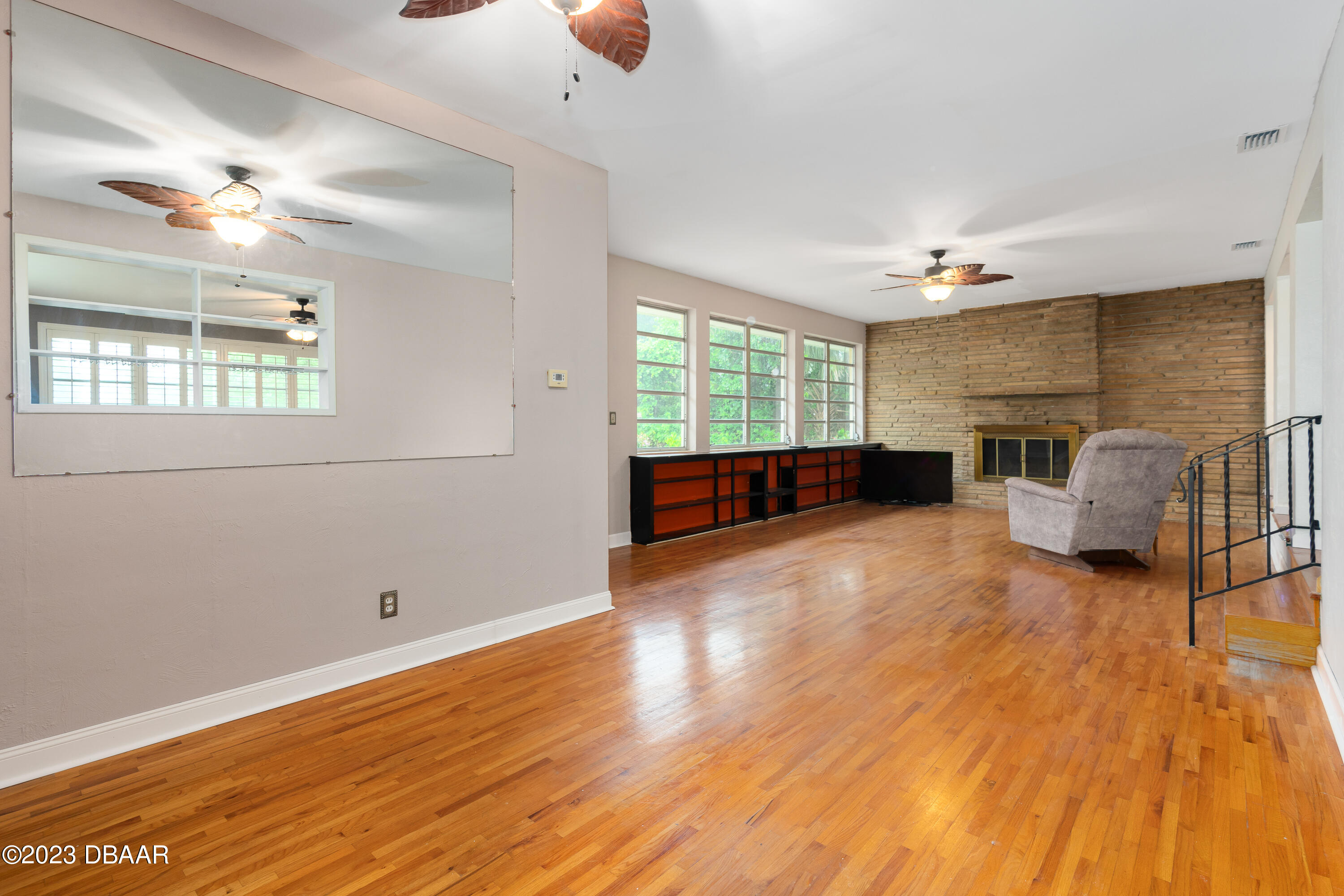 267 South Halifax Drive Ormond Beach, FL 32176 - Photo 24 of 47 a view of a livingroom with furniture a ceiling fan and wooden floor