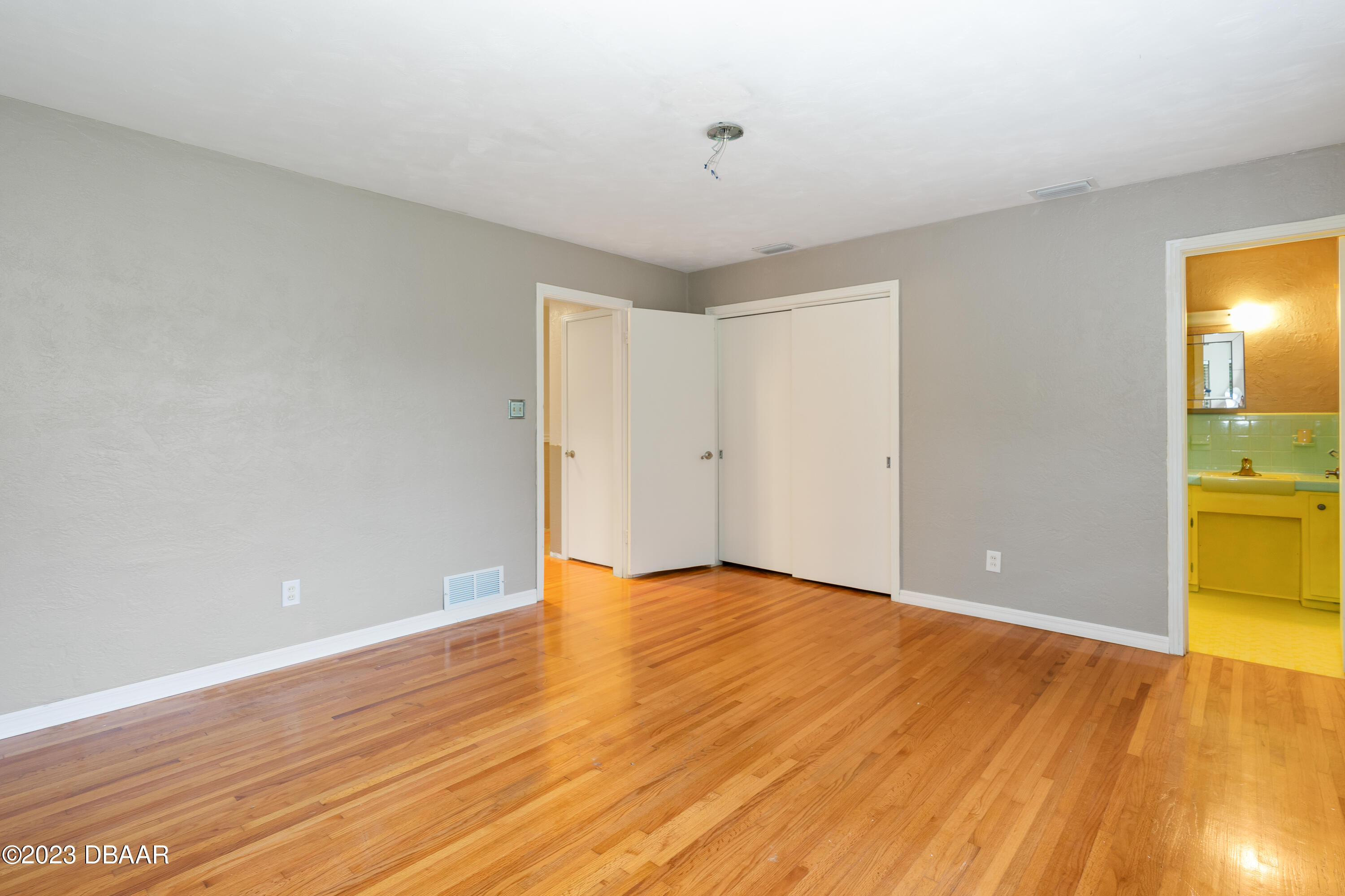 267 South Halifax Drive Ormond Beach, FL 32176 - Photo 26 of 47 a view of an empty room with wooden floor