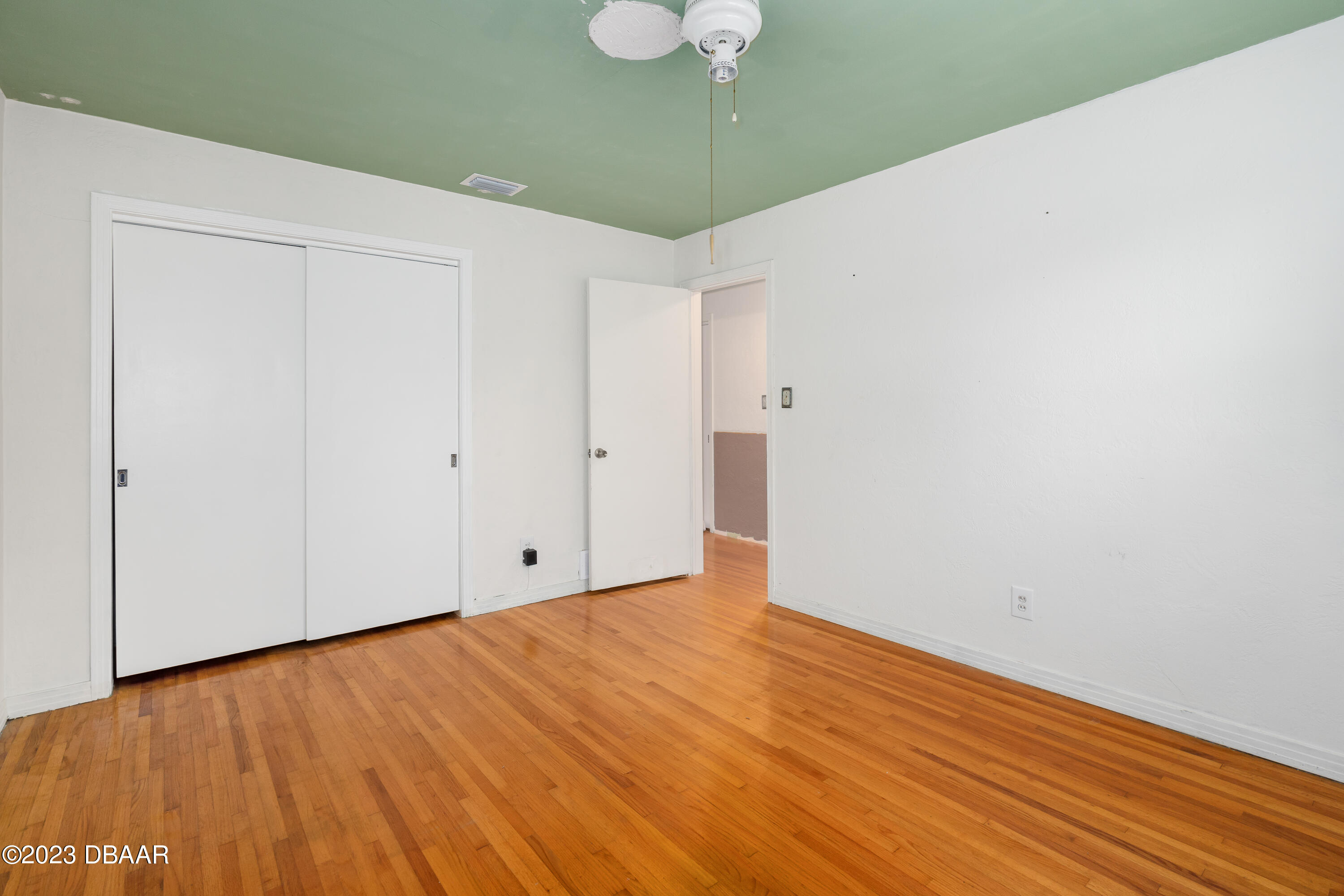 267 South Halifax Drive Ormond Beach, FL 32176 - Photo 31 of 47 a view of an empty room with wooden floor
