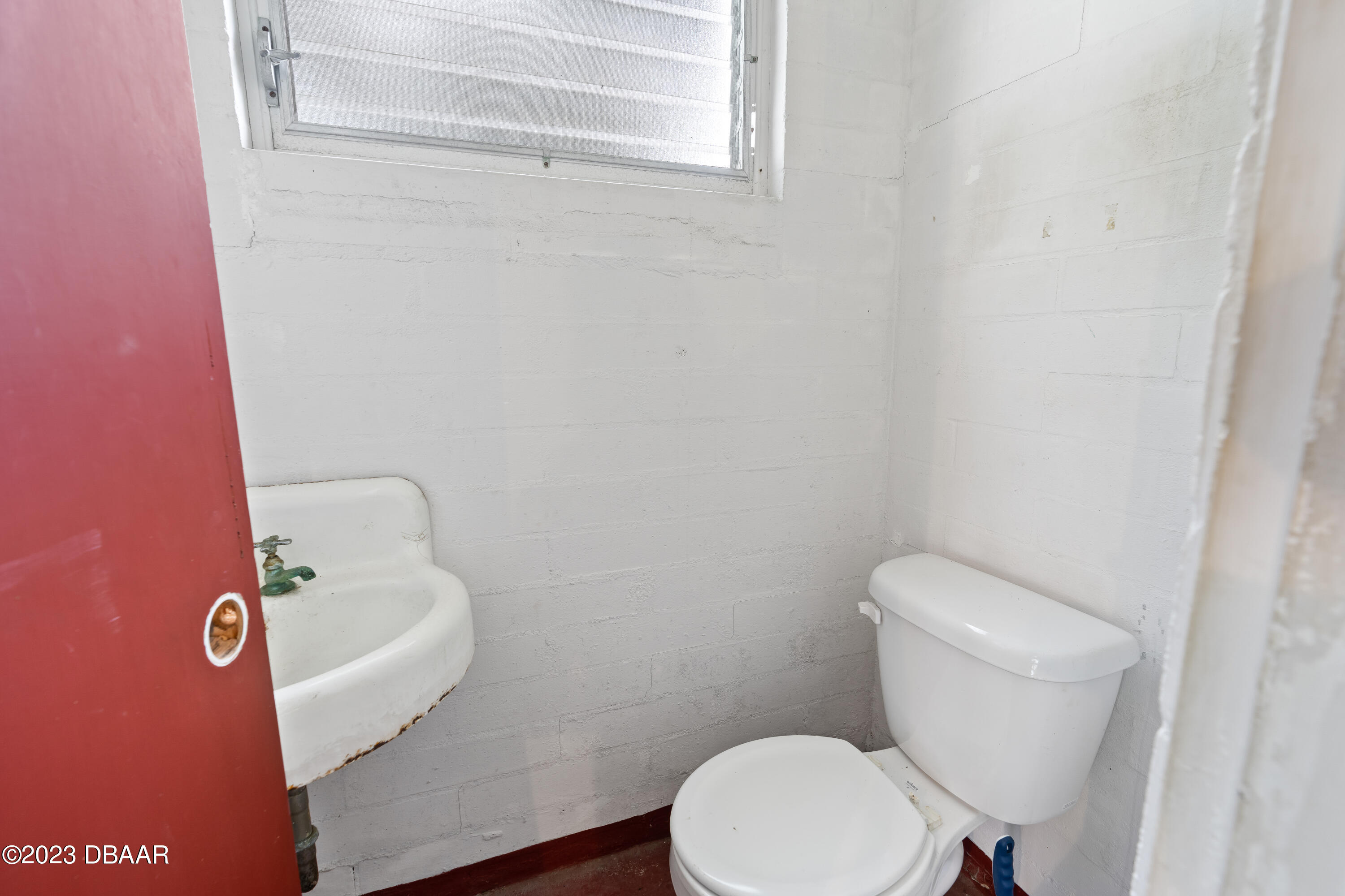 267 South Halifax Drive Ormond Beach, FL 32176 - Photo 37 of 47 a white toilet sitting next to a bathroom sink