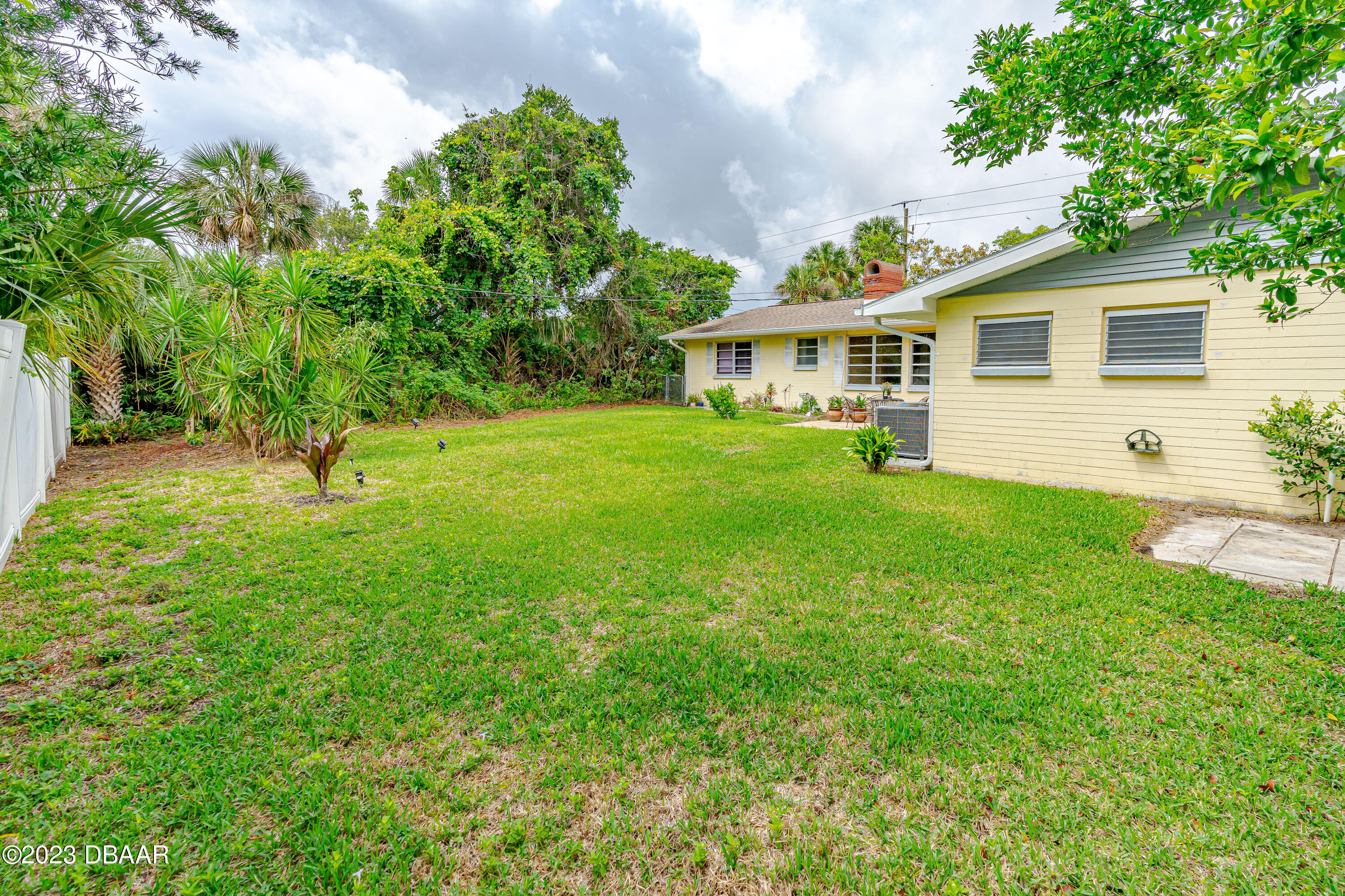 267 South Halifax Drive Ormond Beach, FL 32176 - Photo 10 of 47 a front view of a house with garden