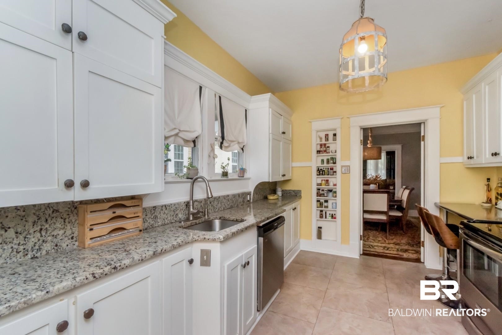 135 Silverwood Street Mobile, AL 36607 - Photo 11 of 32 Kitchen with white cabinetry, hanging light fixtures, light stone counters, stainless steel appliances, and light tile patterned floors
