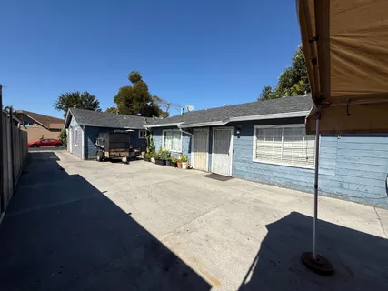 a view of house with outdoor space and sitting area