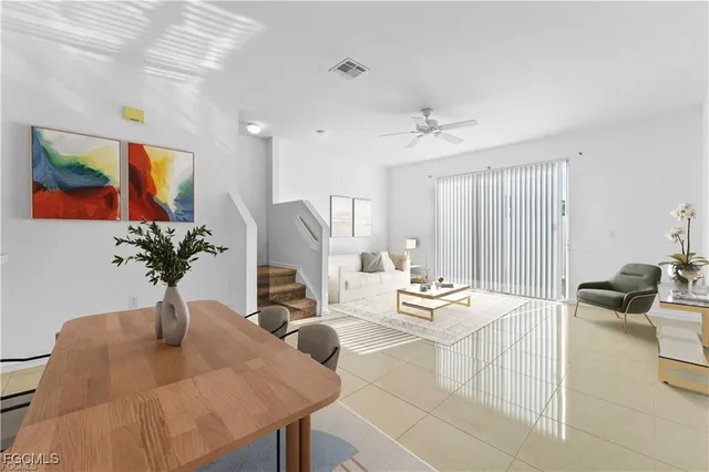 a view of an empty room with a chandelier fan
