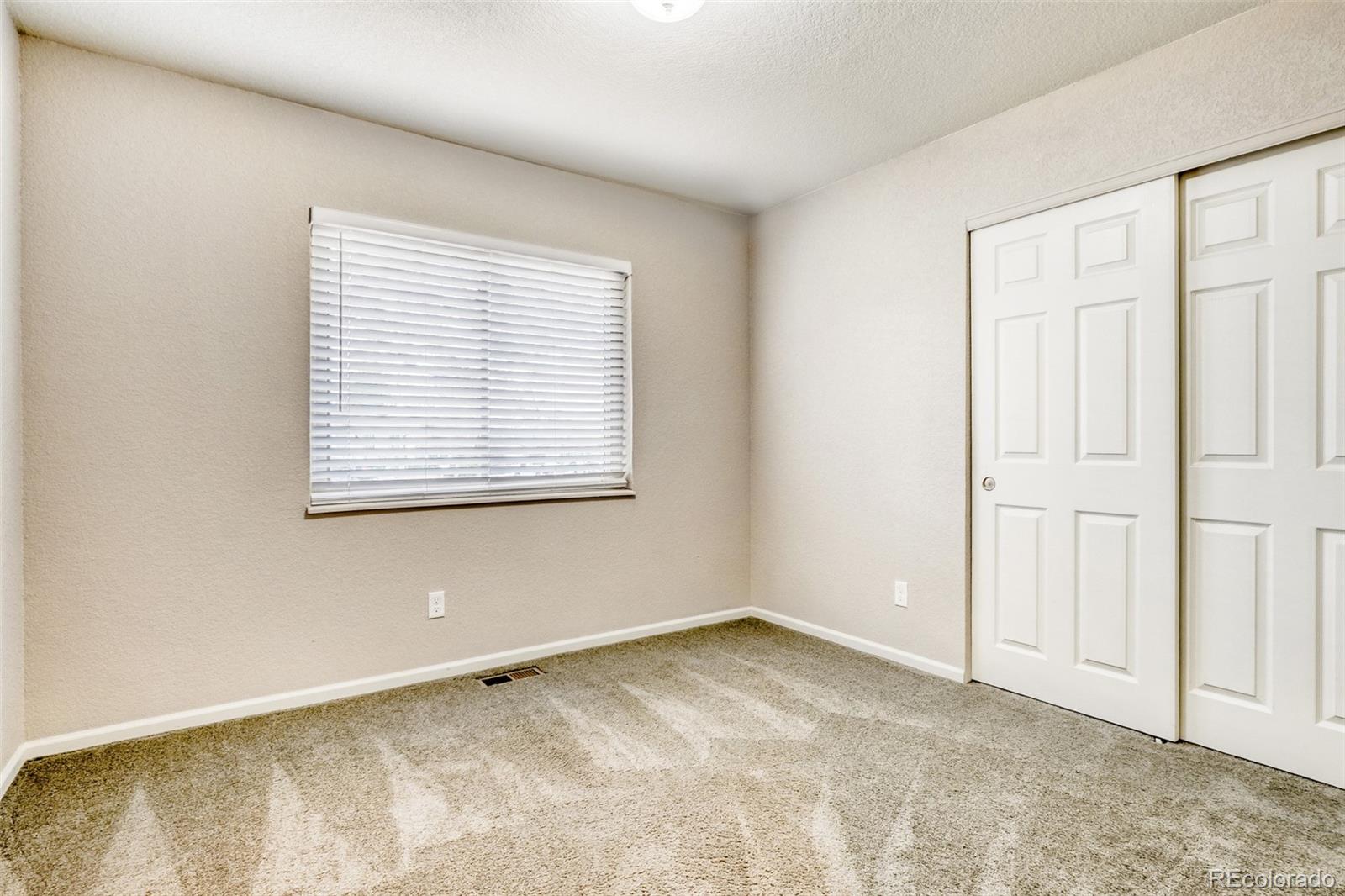 2682 South Quintero Way Aurora, CO 80013 - Photo 18 of 25 an empty room with a window