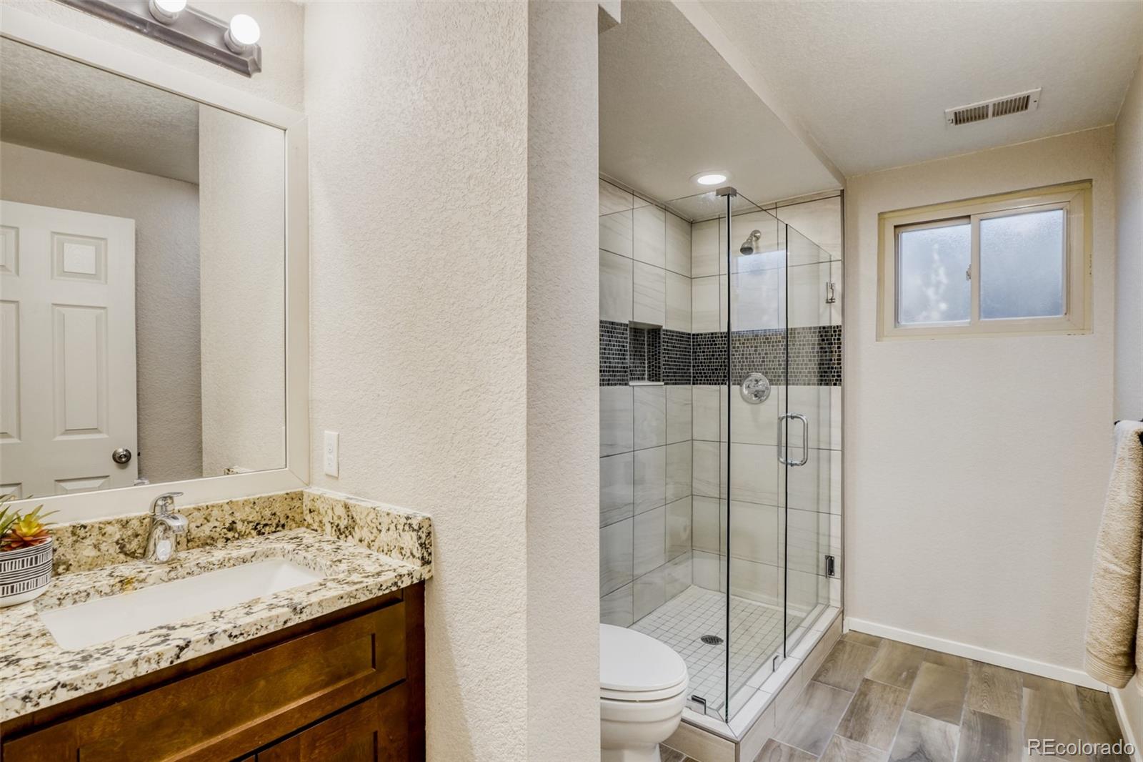 2682 South Quintero Way Aurora, CO 80013 - Photo 20 of 25 a bathroom with a sink toilet and shower