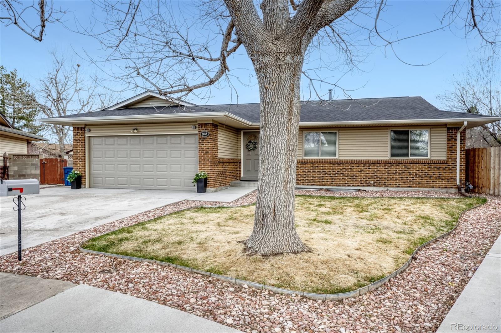 2682 South Quintero Way Aurora, CO 80013 - Photo 2 of 25 a front view of a house with garden