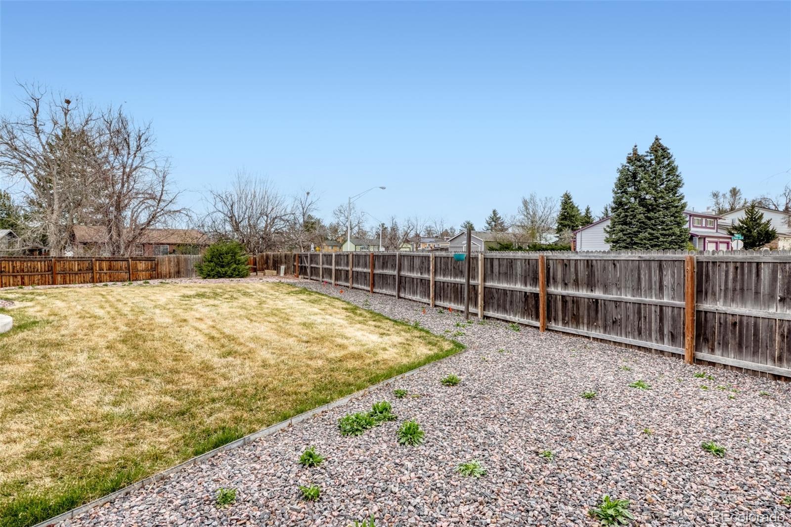 2682 South Quintero Way Aurora, CO 80013 - Photo 24 of 25 a view of a backyard with wooden fence