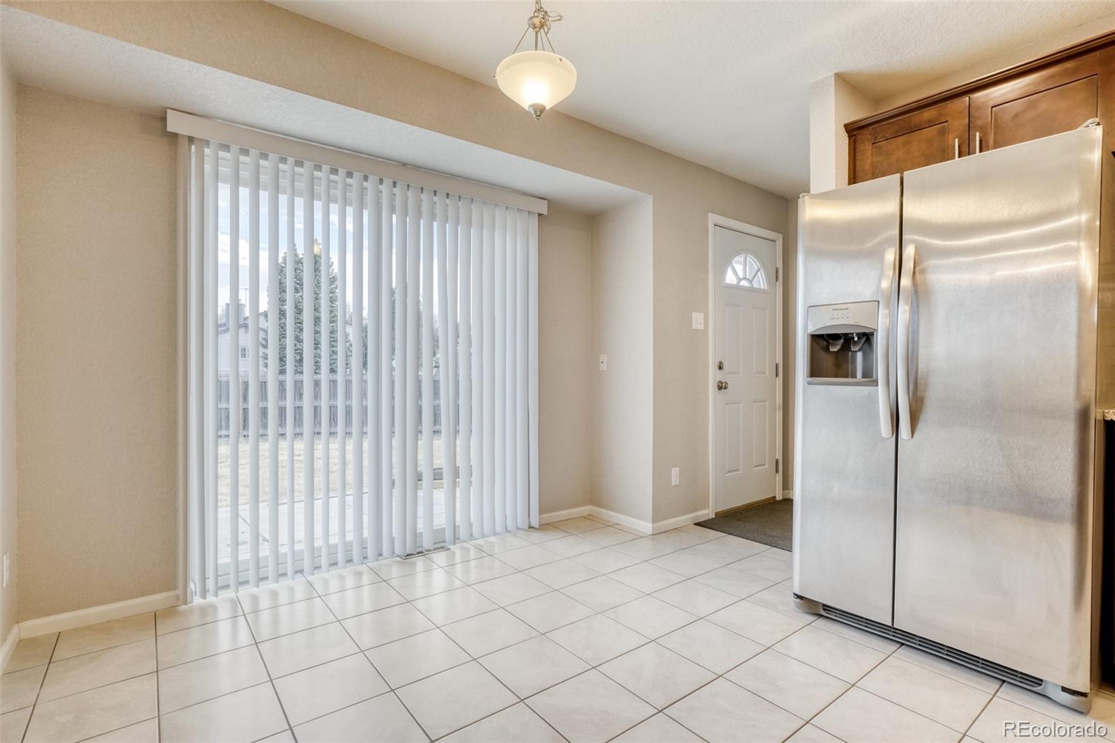 2682 South Quintero Way Aurora, CO 80013 - Photo 6 of 25 a view of an empty room with wooden floor