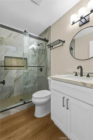 a bathroom with a sink a toilet and a shower