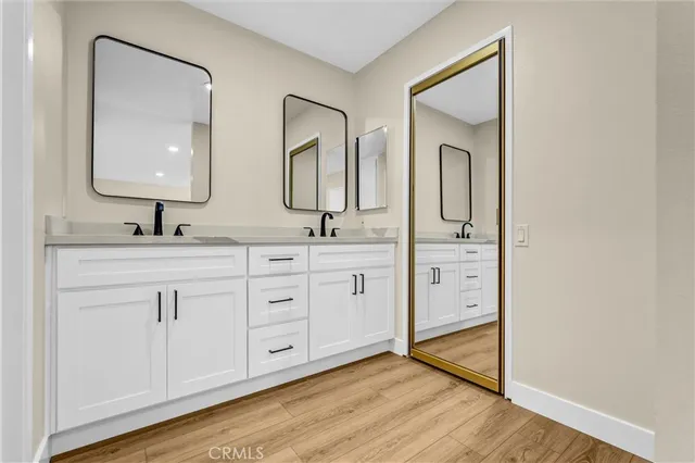 a bathroom with a double vanity sink and mirror