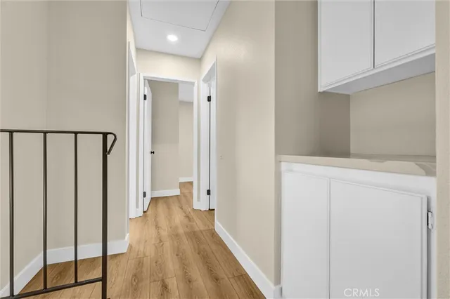 a view of a hallway with wooden floor