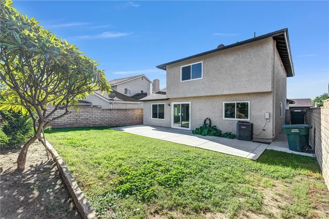 a house view with a sitting space and garden
