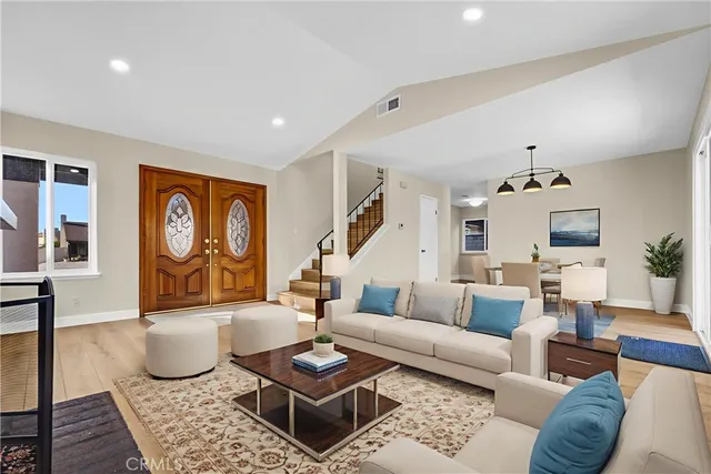 a living room with furniture and wooden floor