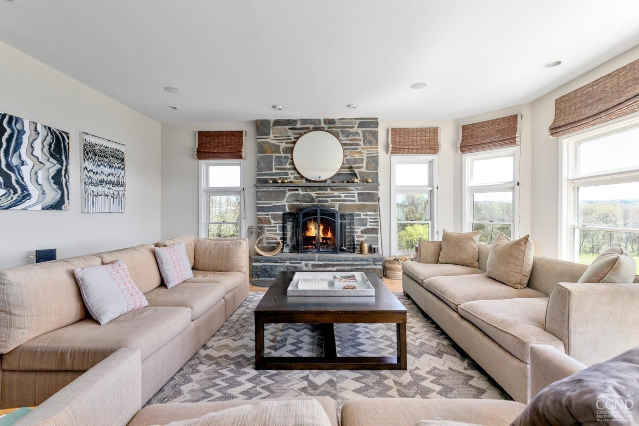 742 Embought Road Catskill, NY 12414 - Photo 4 of 32 a living room with furniture a large window and a fireplace
