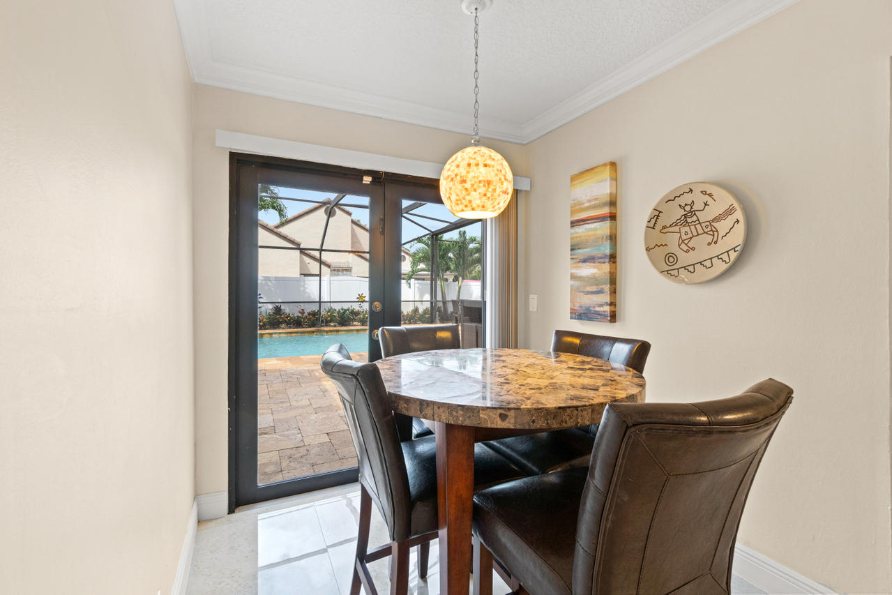 22313 Ensenada Way Boca Raton, FL 33433 - Photo 12 of 44 a view of a dining room with a table and chairs