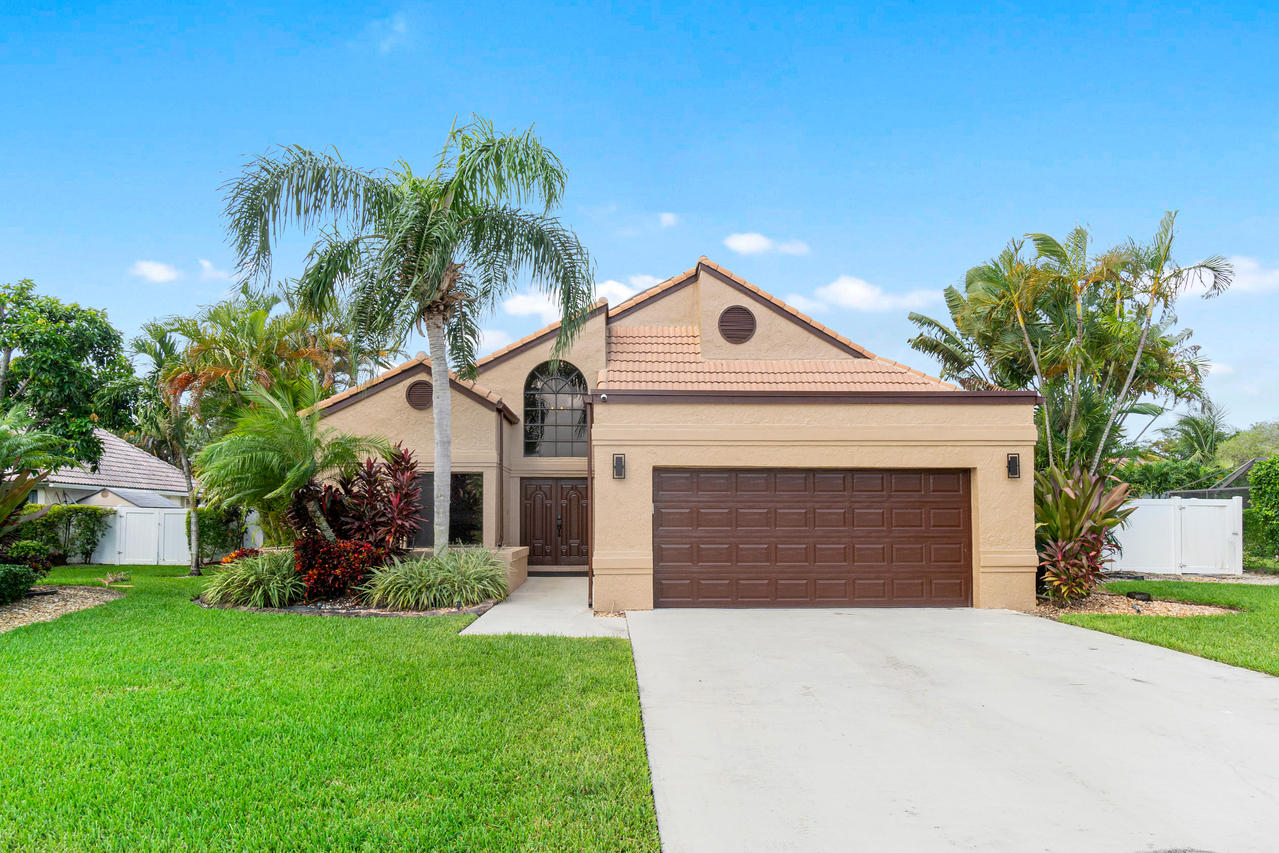 22313 Ensenada Way Boca Raton, FL 33433 - Photo 2 of 44 a front view of a house with a garden and plants