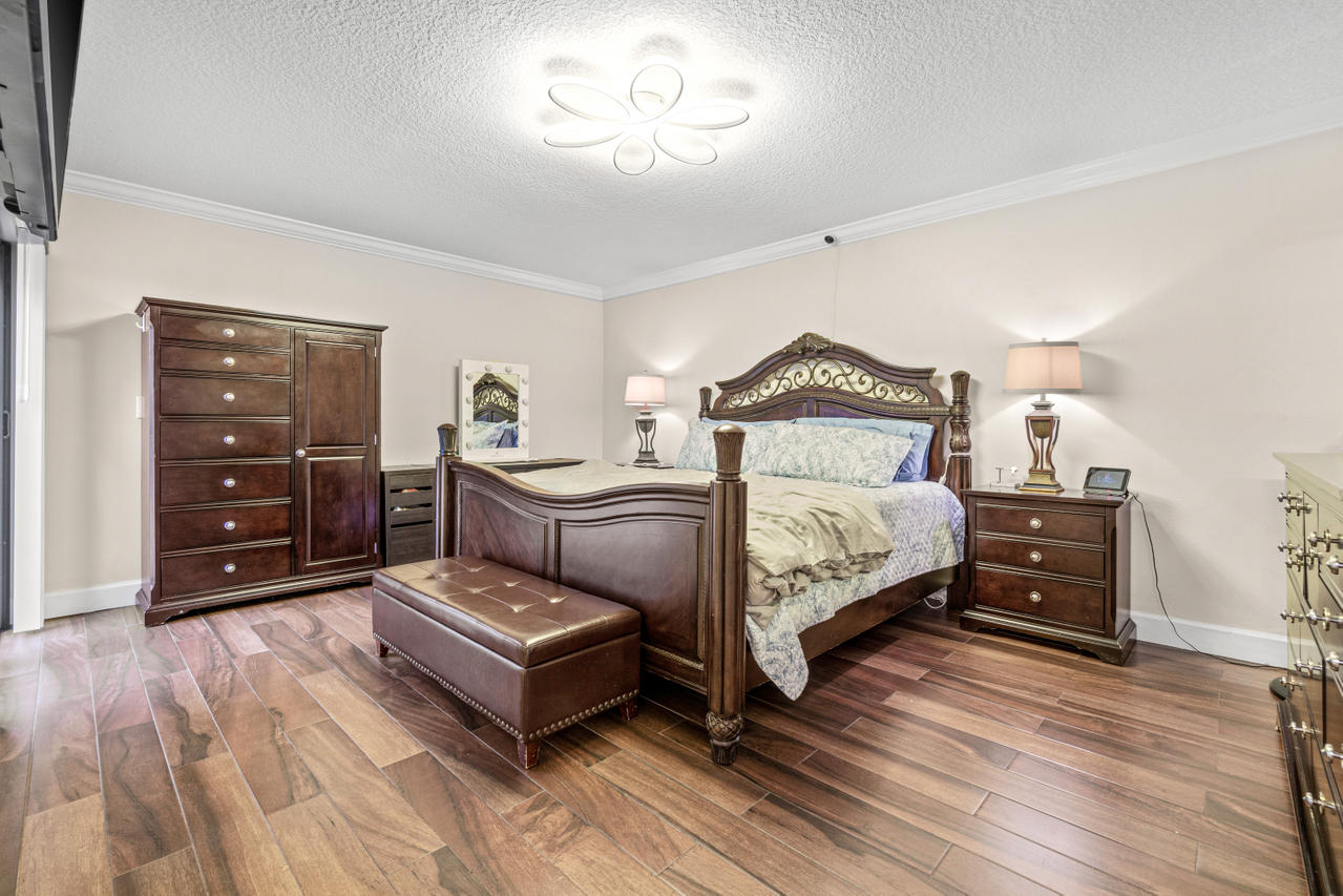 22313 Ensenada Way Boca Raton, FL 33433 - Photo 30 of 44 a bedroom with a bed and a dresser