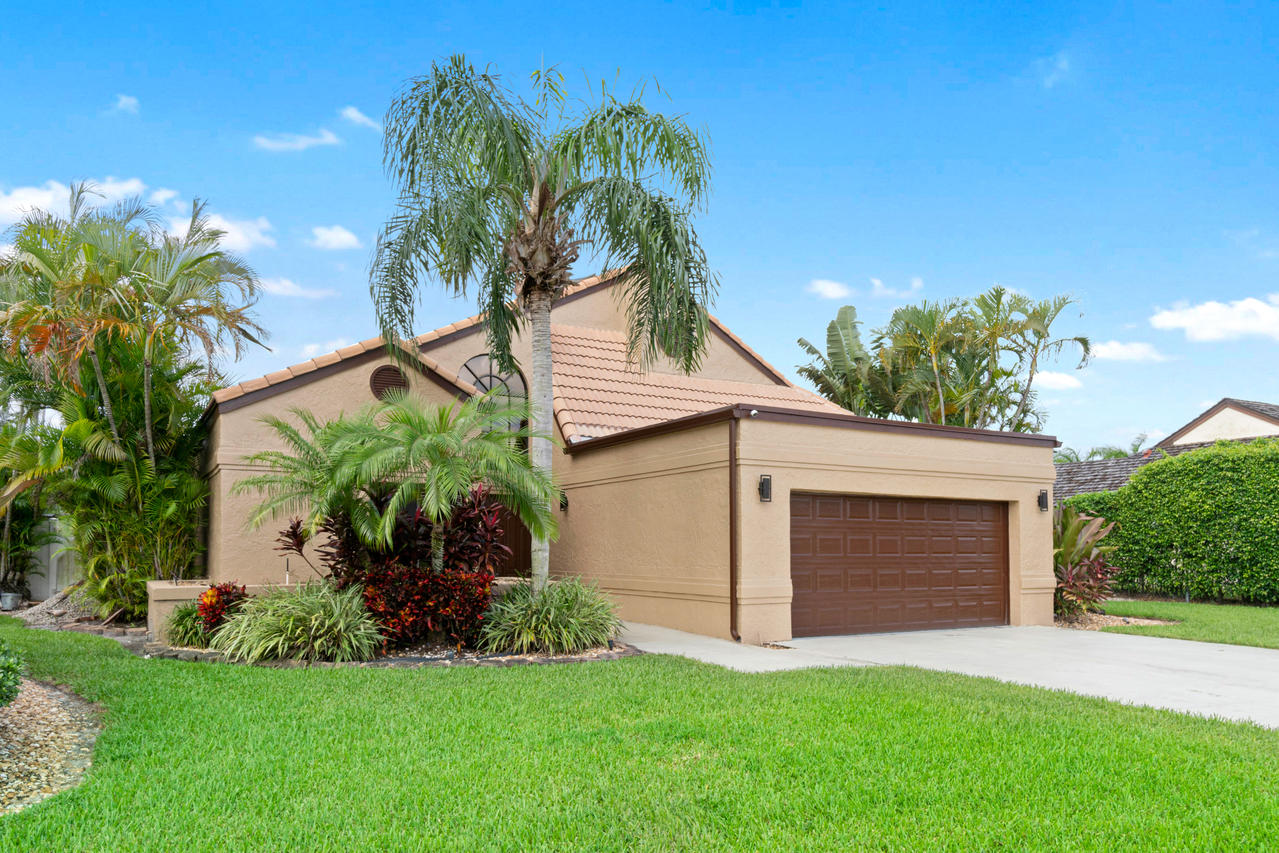 22313 Ensenada Way Boca Raton, FL 33433 - Photo 3 of 44 a front view of a house with a garden and plants
