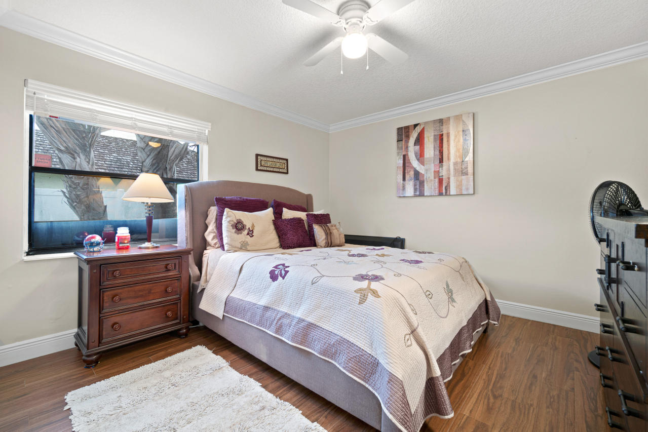 22313 Ensenada Way Boca Raton, FL 33433 - Photo 33 of 44 a bedroom with a bed and a chandelier