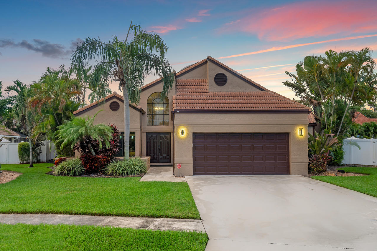 22313 Ensenada Way Boca Raton, FL 33433 - Photo 37 of 44 a front view of a house with a garden and plants