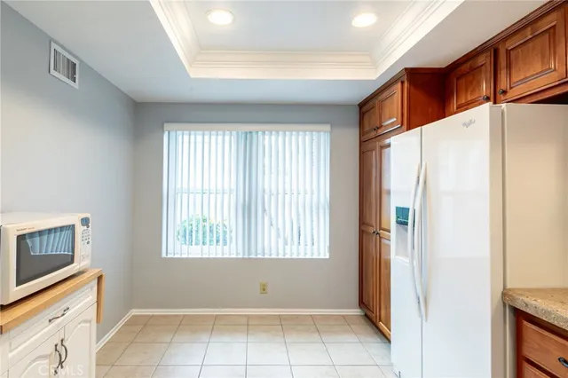 a view of a kitchen with white cabinets