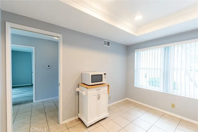 a view of kitchen with wooden floor and electronic appliances