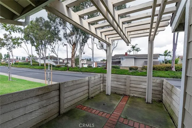 an empty room with wooden floor chandelier and windows