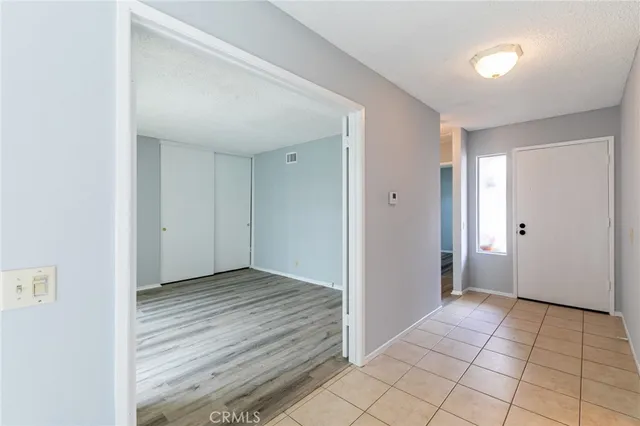 a view of a livingroom with wooden floor and window