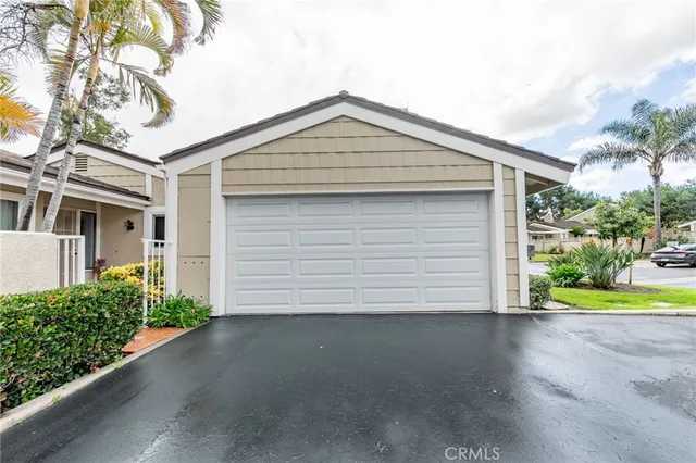 a view of a house with a yard and garage