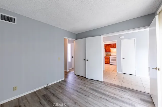 a bathroom with a granite countertop sink a mirror and shower