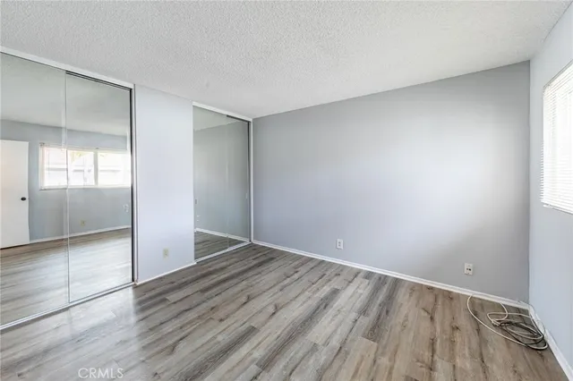 a view of a room with wooden floor and a bathroom