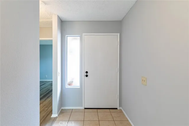 a view of a hallway with a livingroom and a bathroom