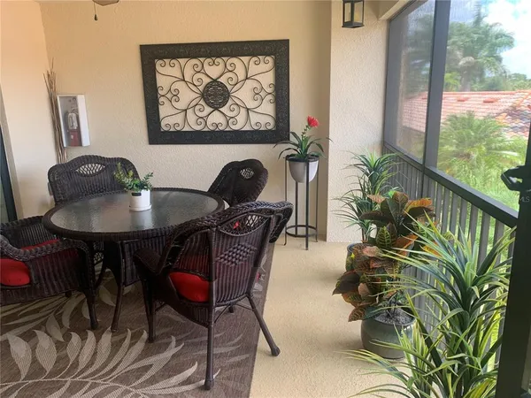 a living room with furniture and a floor to ceiling window