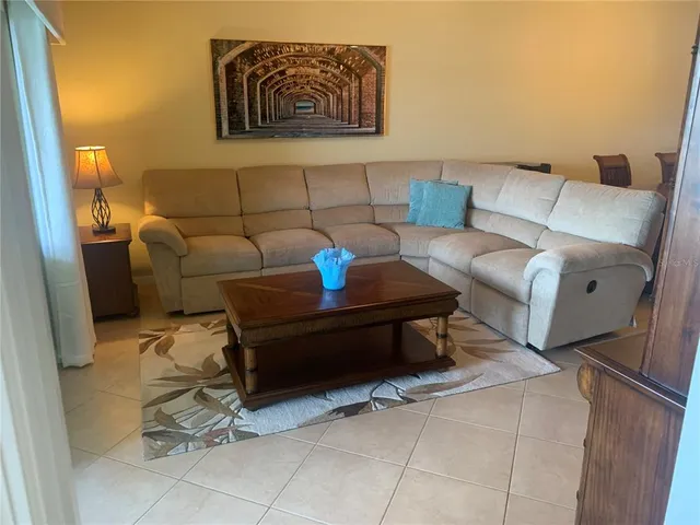 a living room with furniture and a rug