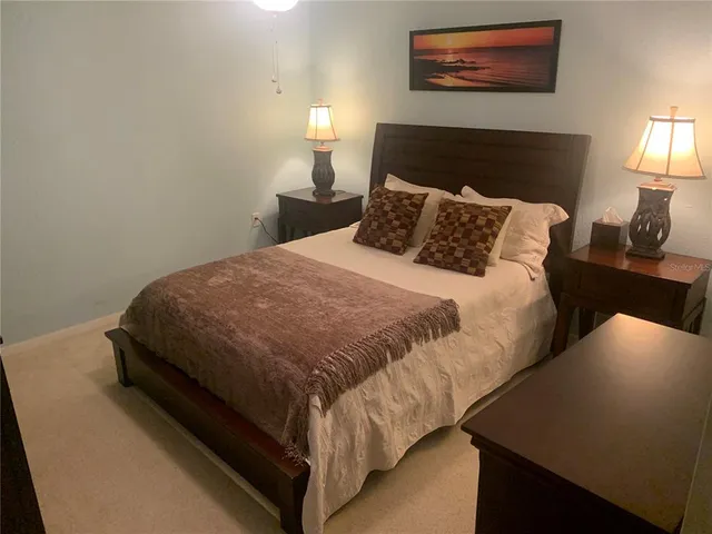 a bedroom with a bed and a lamp